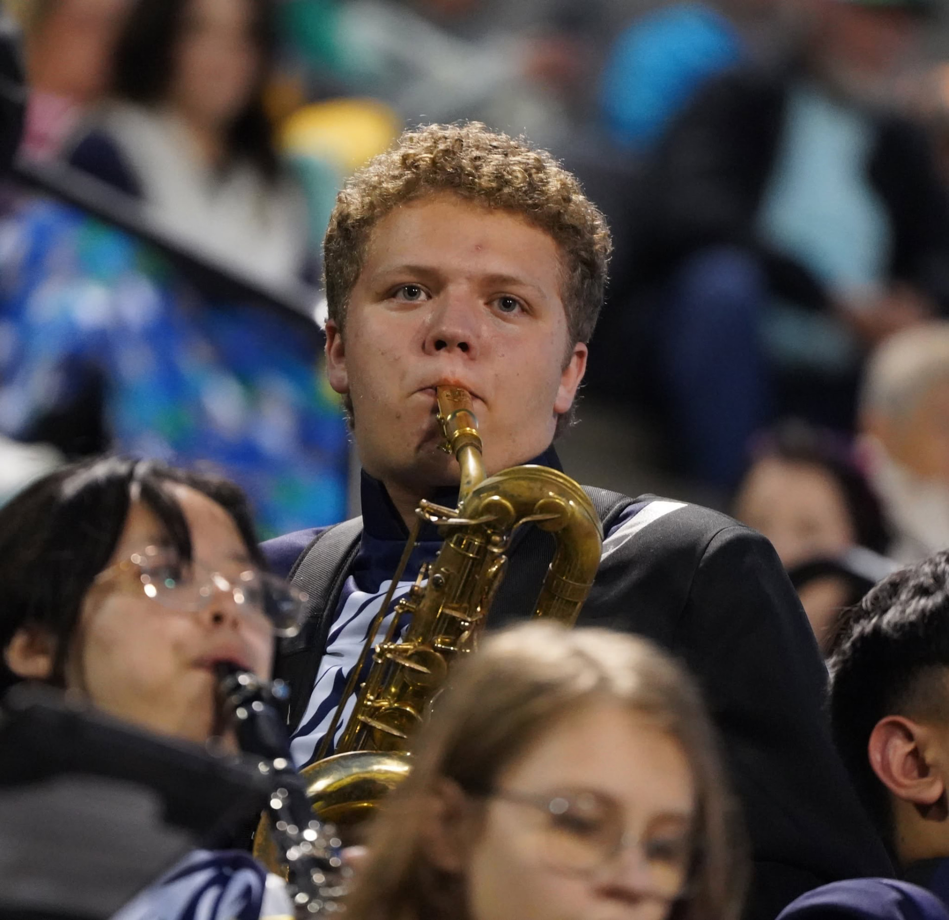 Caden playing saxophone during a band performance